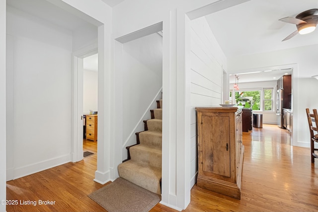 stairway featuring hardwood / wood-style floors and ceiling fan