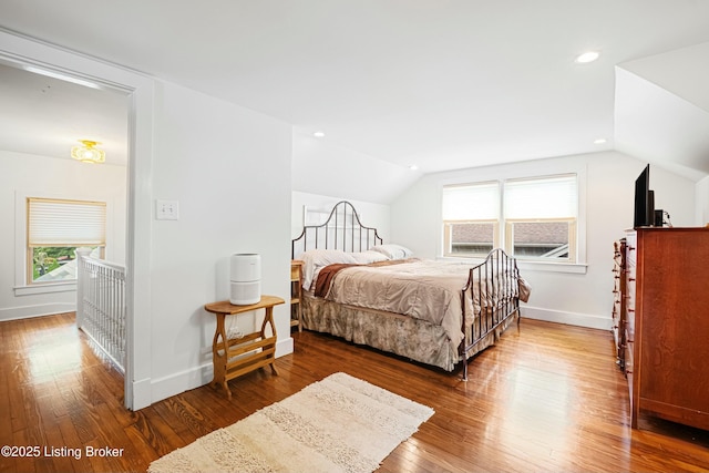 bedroom with lofted ceiling and hardwood / wood-style floors