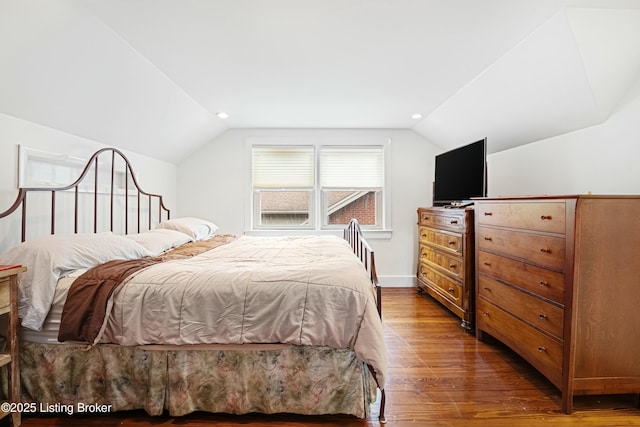 bedroom featuring lofted ceiling and dark hardwood / wood-style flooring