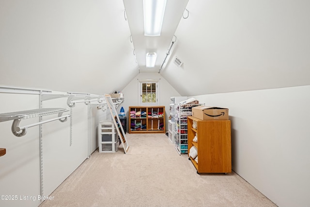 interior space featuring vaulted ceiling and light carpet