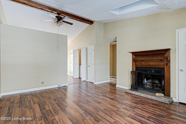 unfurnished living room featuring beamed ceiling, a skylight, ceiling fan, dark hardwood / wood-style flooring, and high vaulted ceiling