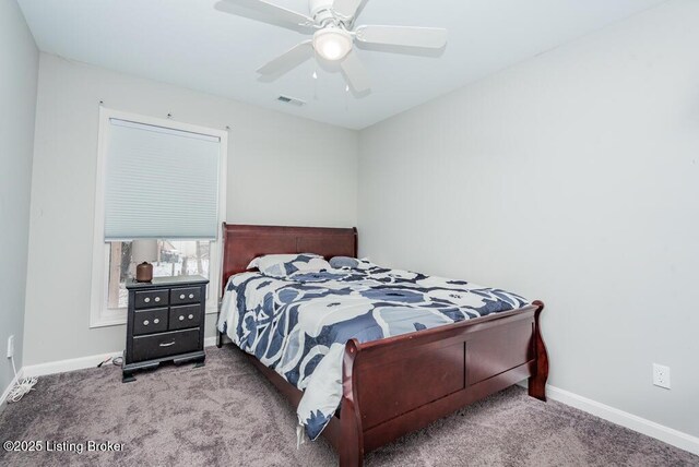 carpeted bedroom featuring baseboards, visible vents, and a ceiling fan