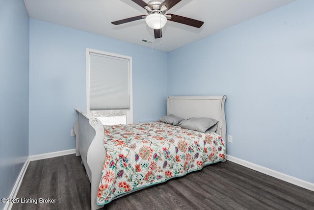 bedroom featuring a ceiling fan, dark wood-style flooring, visible vents, and baseboards