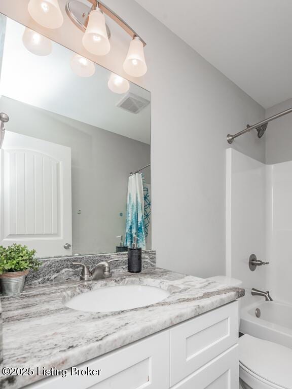 bathroom featuring toilet, visible vents, shower / bath combo with shower curtain, and vanity