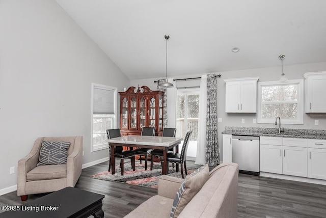 dining area with dark wood-style floors, high vaulted ceiling, and baseboards