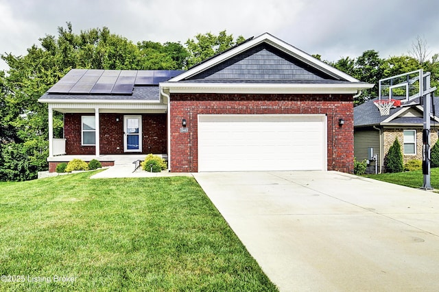 view of front of property with roof mounted solar panels, a front lawn, concrete driveway, and brick siding