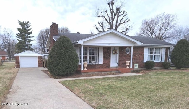 ranch-style house featuring an outbuilding, a porch, a garage, and a front yard