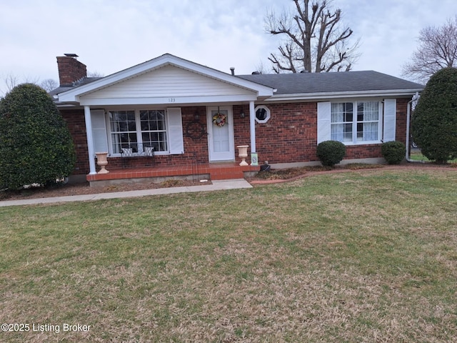 ranch-style home with covered porch and a front lawn