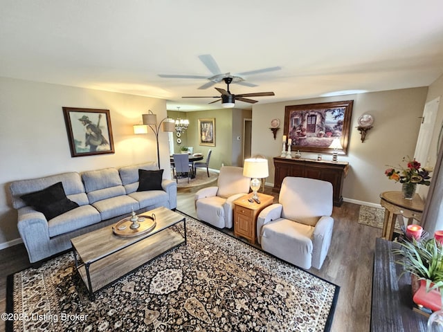 living room with hardwood / wood-style flooring and ceiling fan with notable chandelier