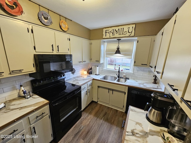 kitchen featuring sink, backsplash, dark hardwood / wood-style flooring, hanging light fixtures, and black appliances