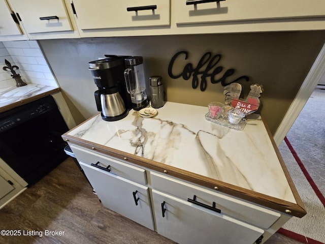 interior details featuring white cabinetry, dark hardwood / wood-style floors, dishwasher, and decorative backsplash