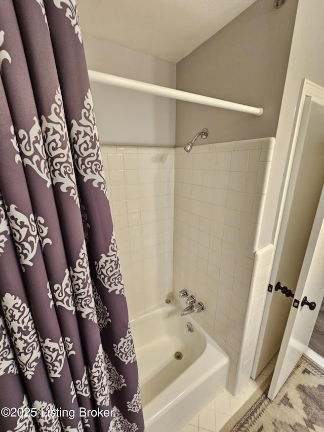 bathroom with shower / bathtub combination with curtain and tile patterned floors