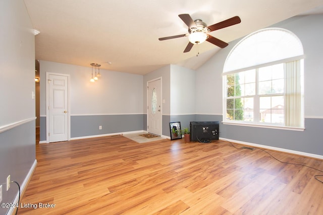 unfurnished living room with ceiling fan, vaulted ceiling, and light hardwood / wood-style flooring