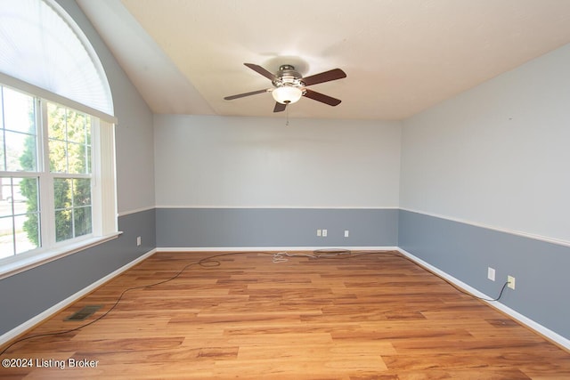 spare room featuring ceiling fan, vaulted ceiling, and light hardwood / wood-style floors