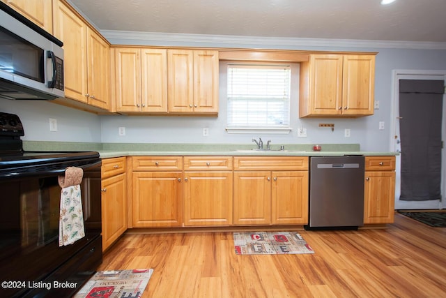 kitchen with ornamental molding, appliances with stainless steel finishes, sink, and light hardwood / wood-style flooring