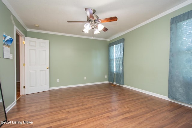 unfurnished room featuring wood-type flooring, ornamental molding, and ceiling fan