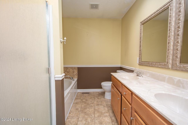 bathroom featuring vanity, tile patterned floors, a tub, and toilet