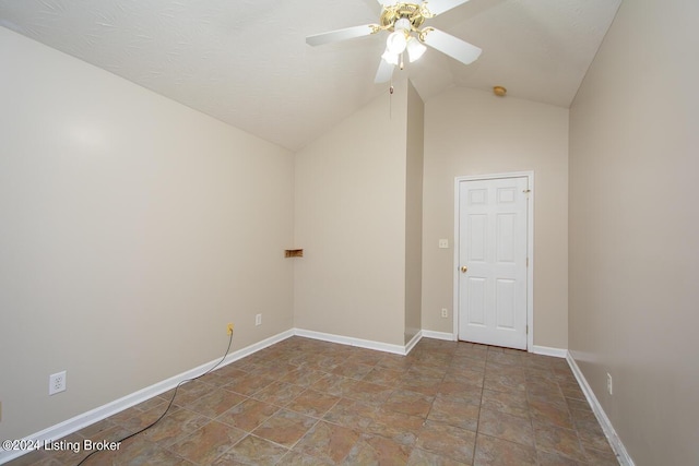 spare room featuring lofted ceiling and ceiling fan