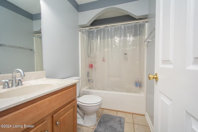 full bathroom with shower / tub combo with curtain, tile patterned floors, toilet, and vanity