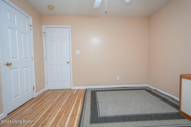 empty room with hardwood / wood-style floors and ceiling fan