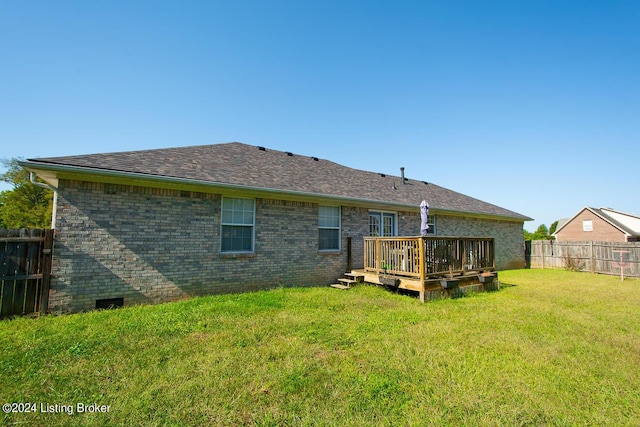 back of house featuring a yard and a deck