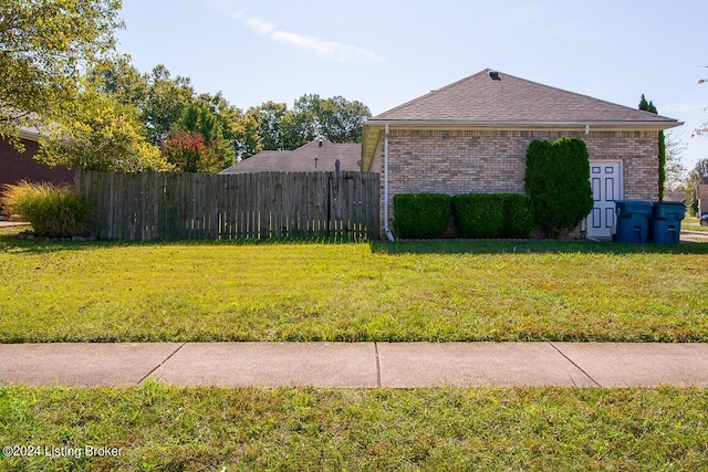 view of side of home with a lawn