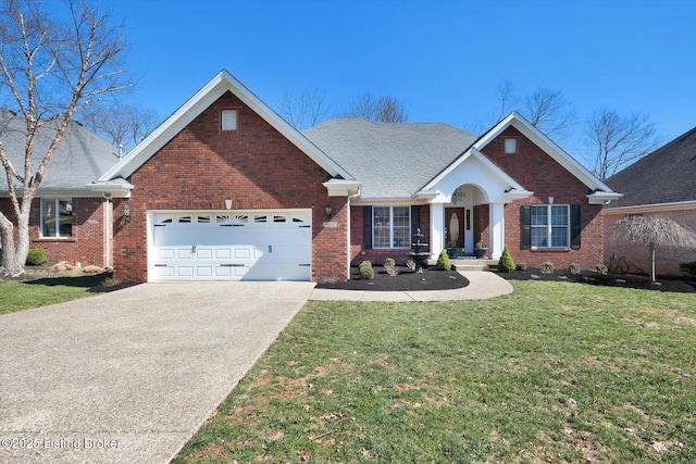 view of front of house featuring a front yard, roof with shingles, concrete driveway, a garage, and brick siding