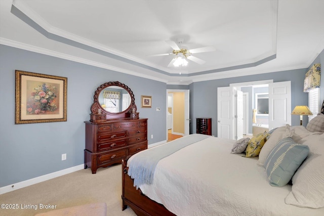 bedroom with a raised ceiling, light colored carpet, baseboards, and ornamental molding