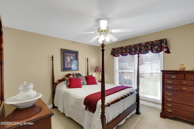 bedroom featuring ceiling fan, baseboards, and light carpet