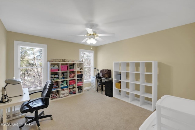 carpeted home office with ceiling fan