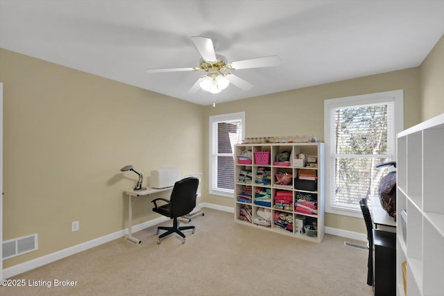 office with carpet flooring, baseboards, visible vents, and ceiling fan