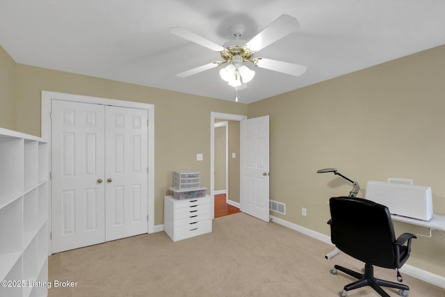 carpeted office space with visible vents, baseboards, and ceiling fan