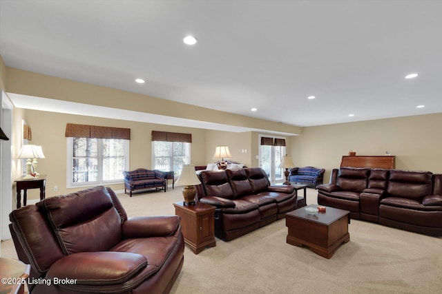 living area featuring recessed lighting and light carpet