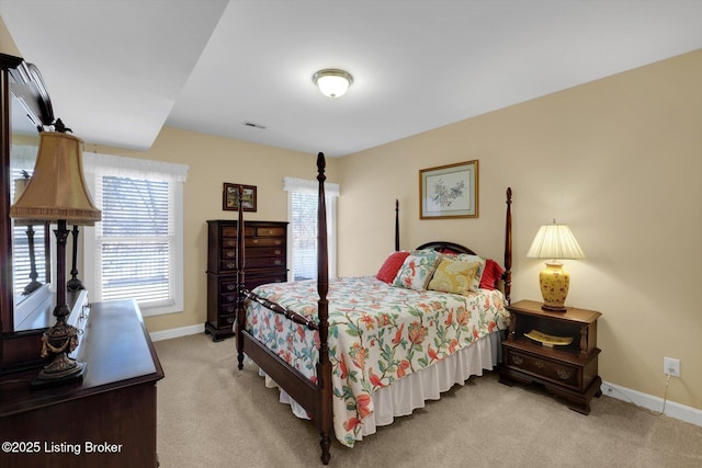 bedroom featuring visible vents, light colored carpet, and baseboards