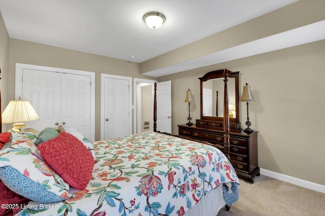 bedroom with a closet, baseboards, and light colored carpet