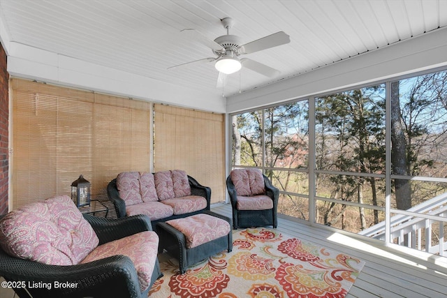 sunroom with plenty of natural light and a ceiling fan