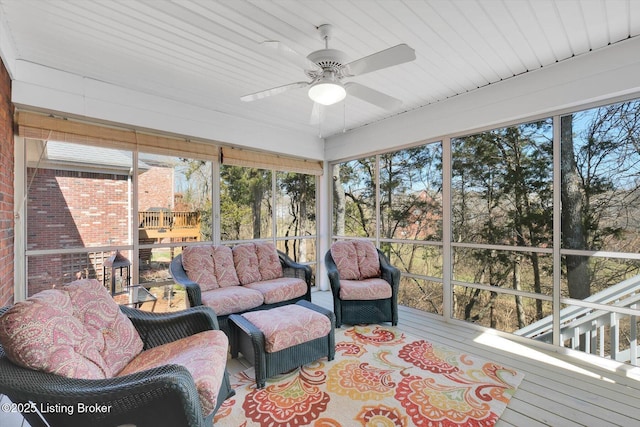 sunroom featuring ceiling fan