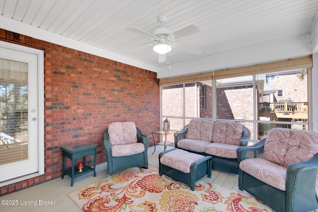 sunroom with plenty of natural light and ceiling fan