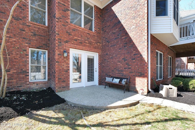 rear view of property with ac unit, a patio area, and brick siding