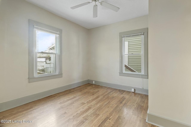 empty room with light wood-type flooring, ceiling fan, and a textured ceiling