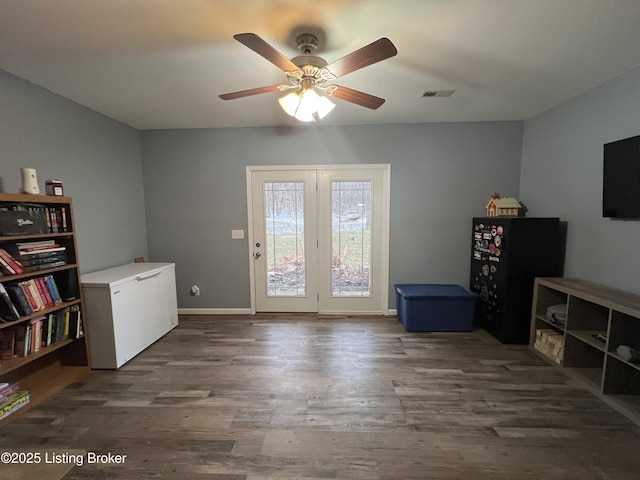 interior space with ceiling fan and dark hardwood / wood-style flooring