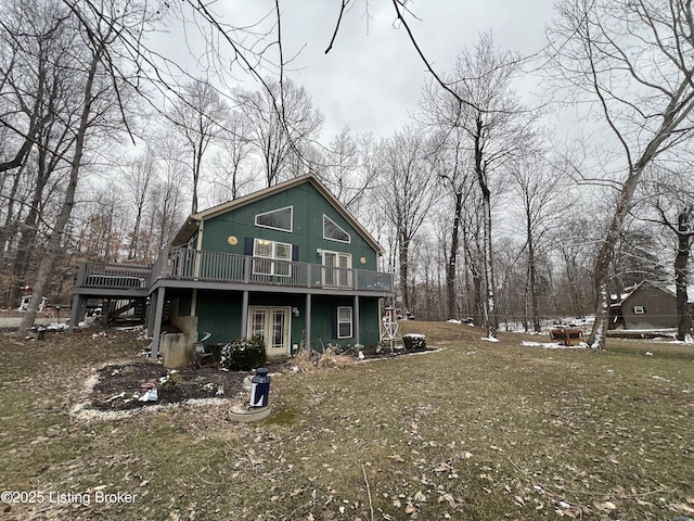 back of property featuring a yard and a deck