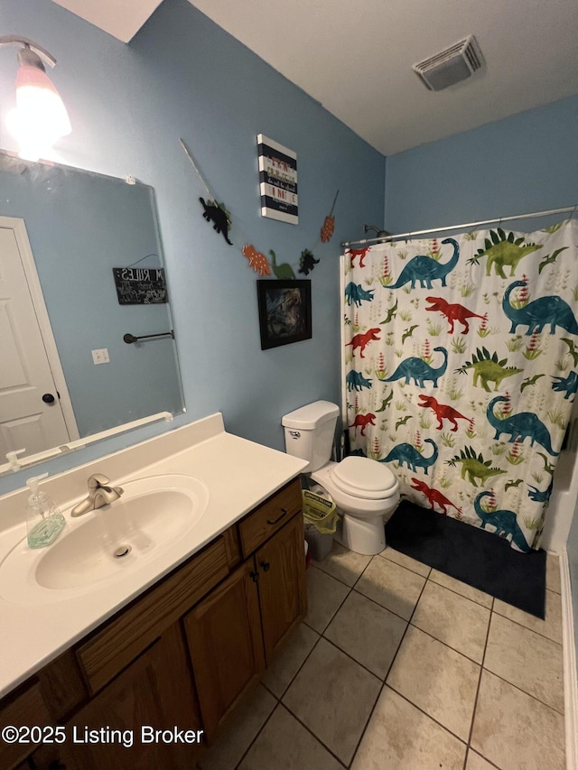 bathroom with vanity, tile patterned floors, and toilet