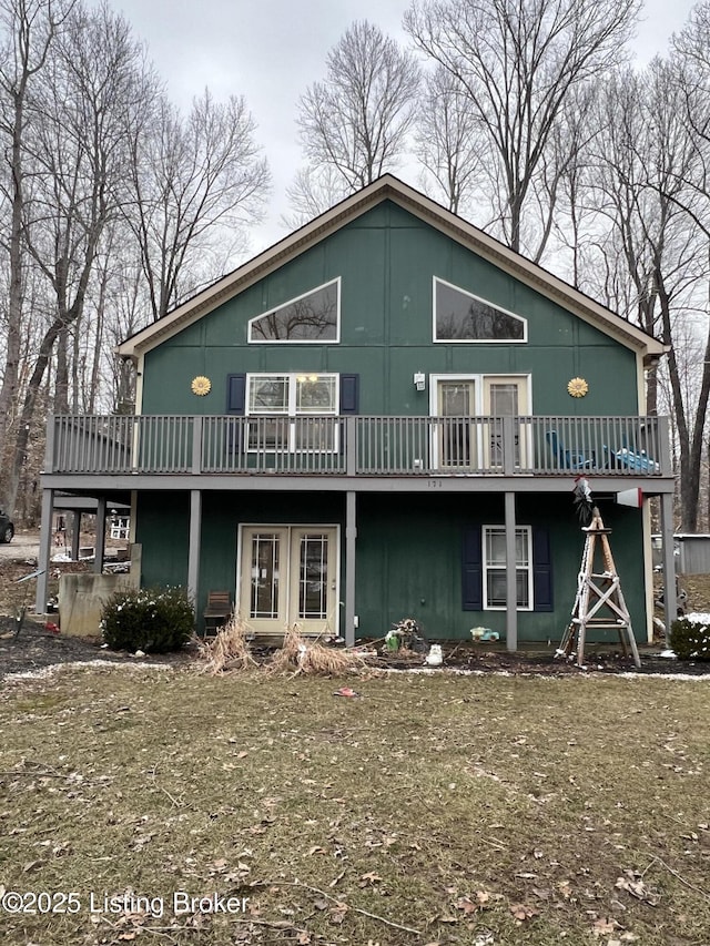 rear view of property with a lawn and a deck