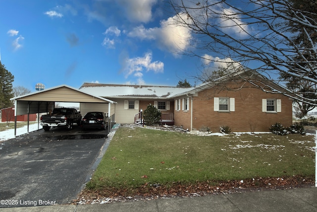 single story home featuring a carport and a lawn