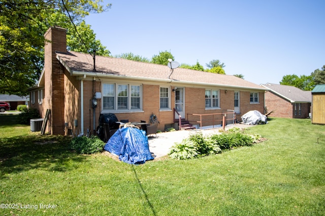 405 Wallace Ave, Leitchfield, KY 42754 - back of house featuring a patio, a chimney, brick siding, a lawn, and central air condition unit