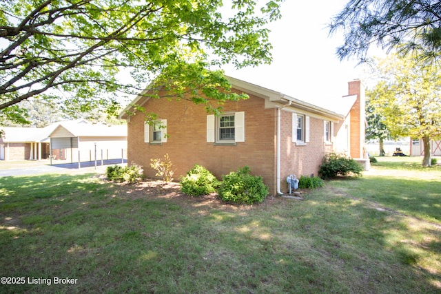 405 Wallace Ave, Leitchfield, KY 42754 - view of property exterior with a yard, brick siding, and a chimney
