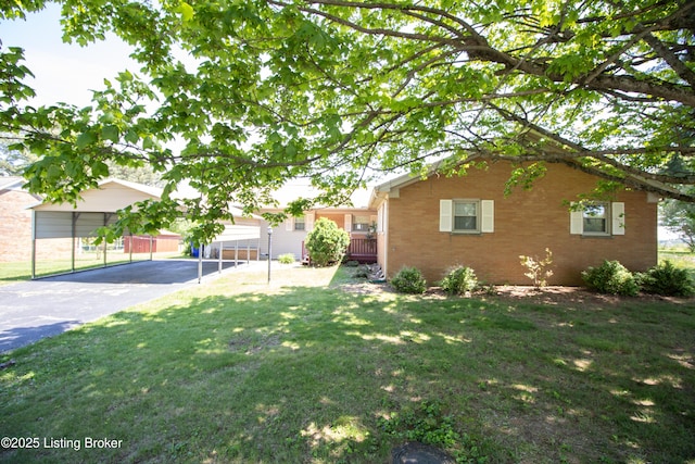 405 Wallace Ave, Leitchfield, KY 42754 - exterior space featuring brick siding, a front yard, and aphalt driveway