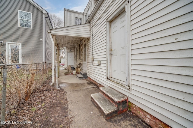 entrance to property featuring fence