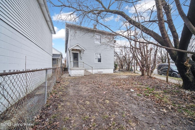 rear view of house with fence